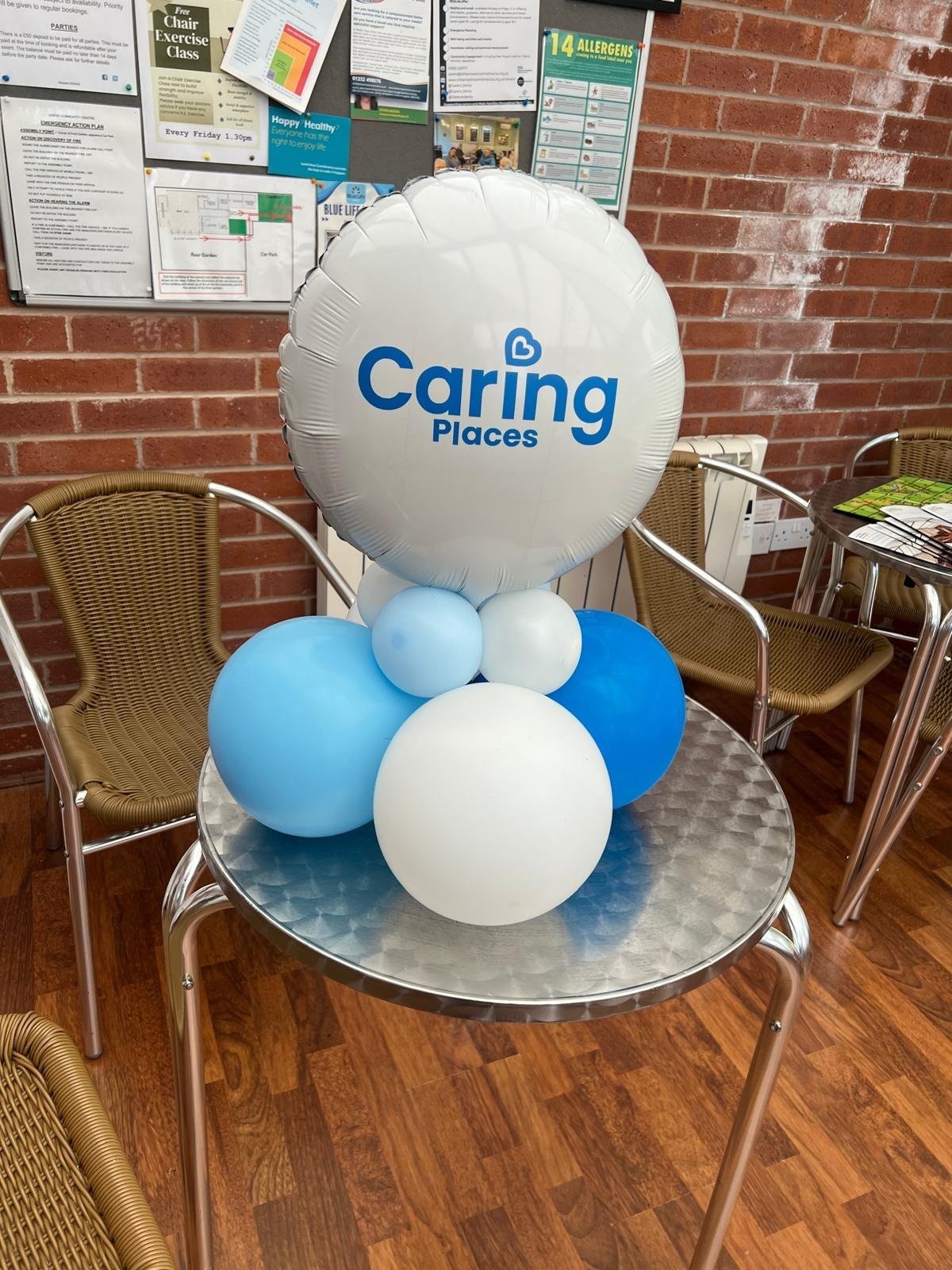 A Caring Places branded balloon centrepiece in the welcoming reception area